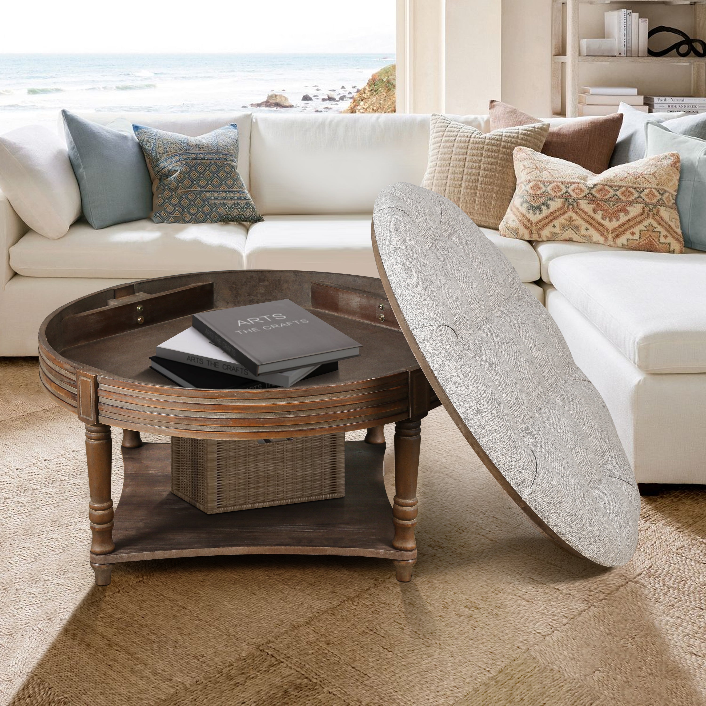 Living room with a white sectional sofa, round wooden coffee table, and decorative pillows.