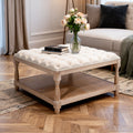 Wooden coffee table with upholstered top in a living room setting