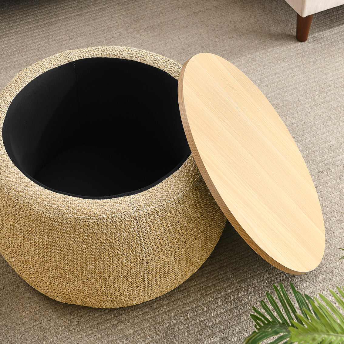 Round woven storage ottoman with a wooden lid on a carpeted floor.