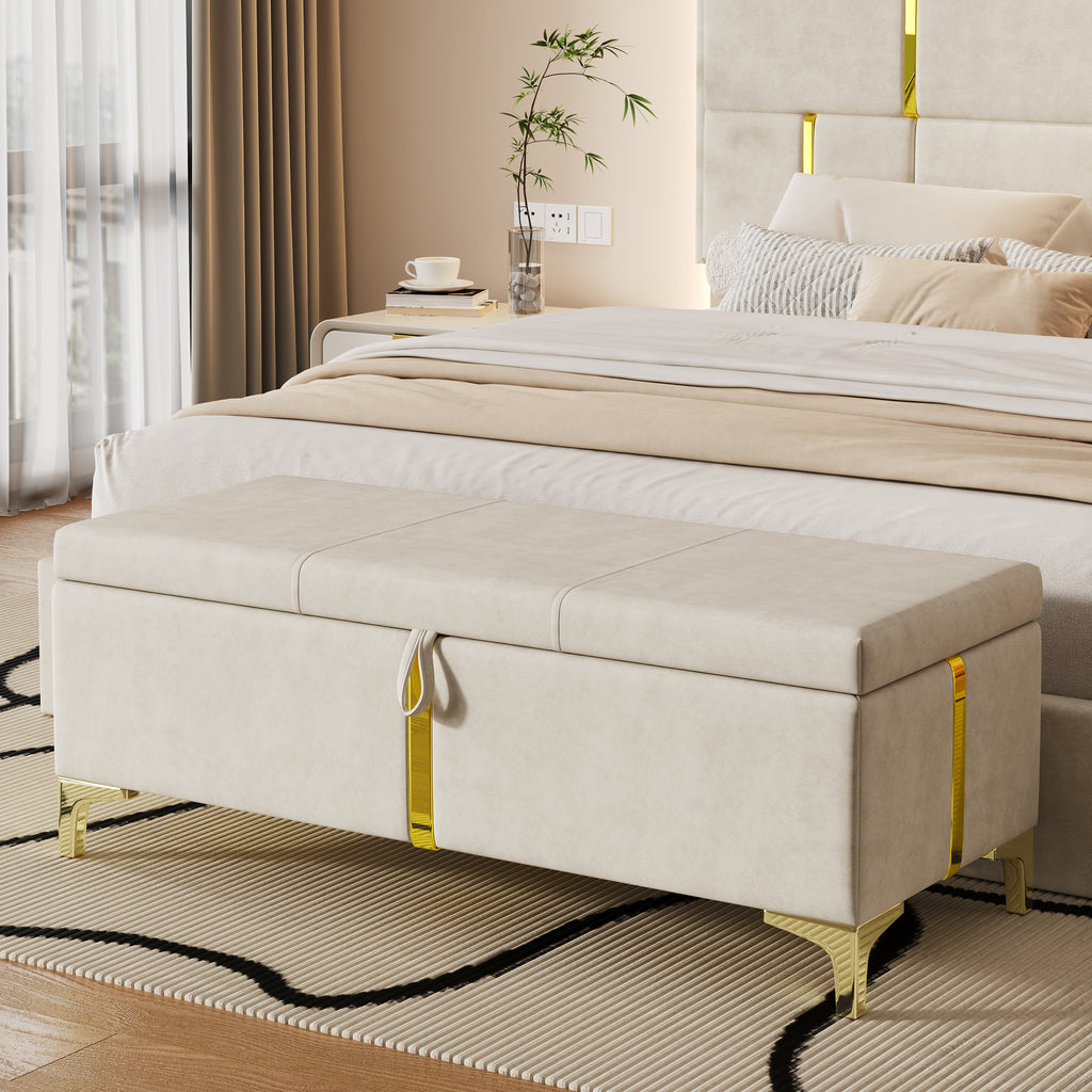 Beige storage bench in front of a bed in a bedroom setting