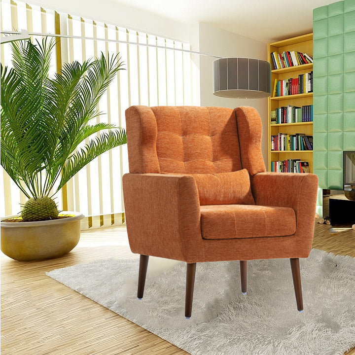 Orange armchair in a living room with a bookshelf and plant