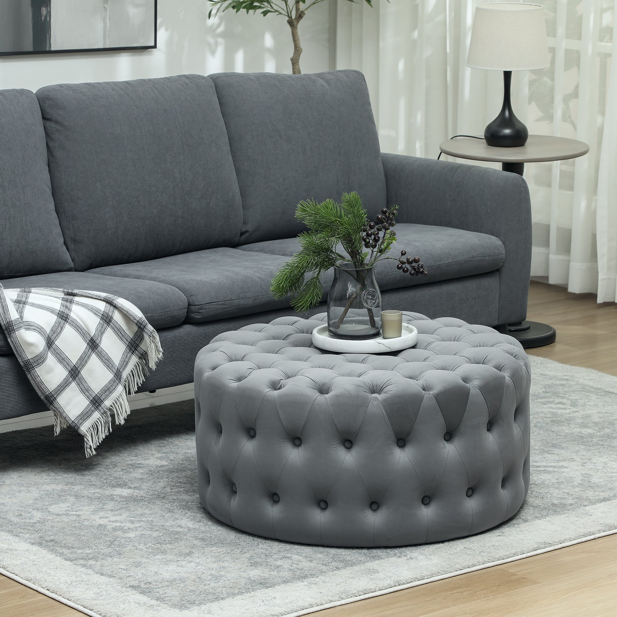 Velvet round coffee table ottoman in dark gray modern living room