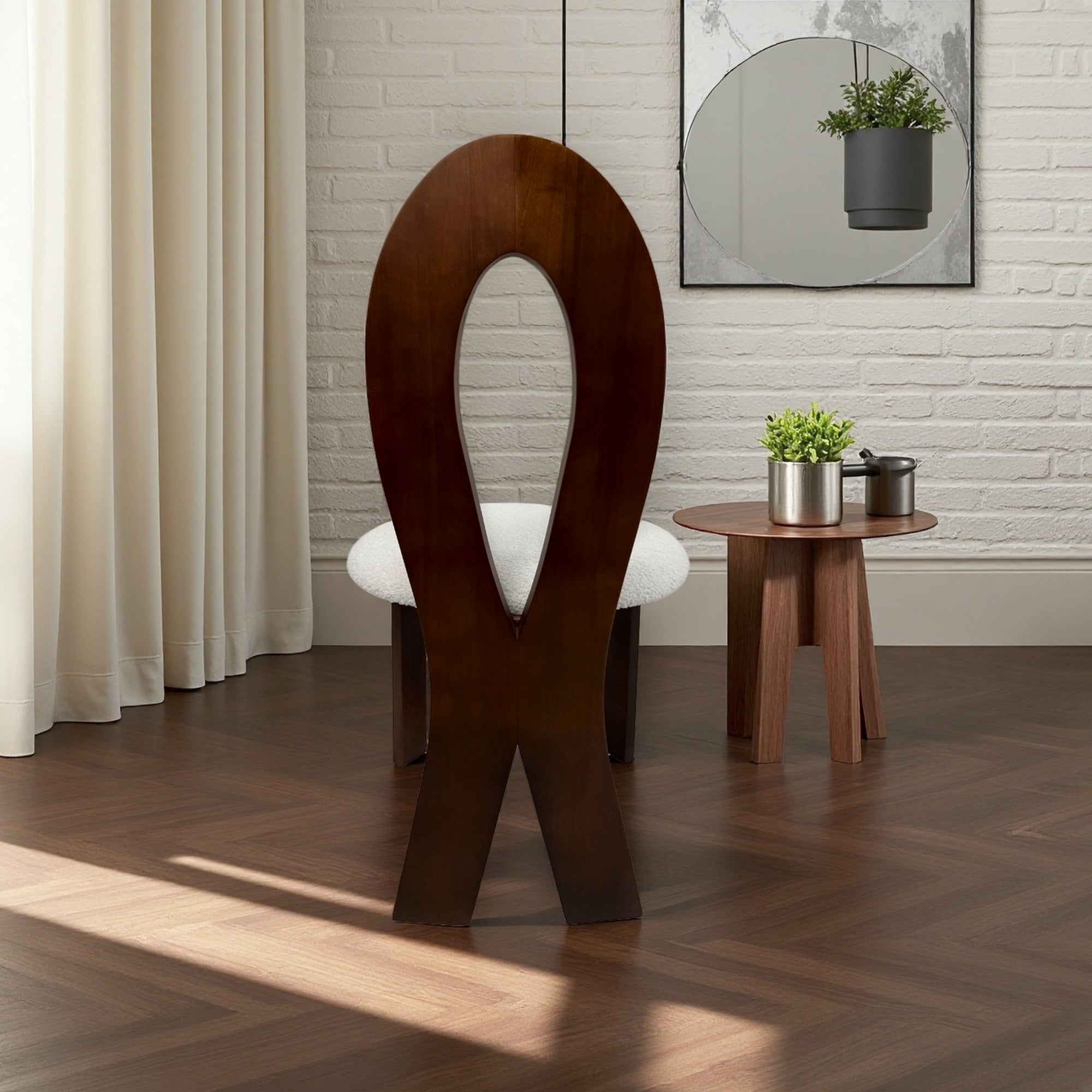 Wooden chair with a unique design in a room with a mirror and plants.
