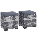 Two woven stools with dark cushions on a white background